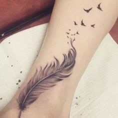 a feather with birds flying around it on the ankle tattoo designs for women and men