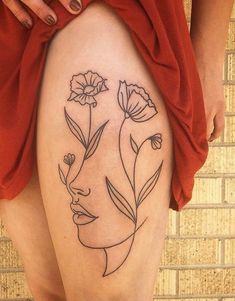 a woman's thigh with flowers on it