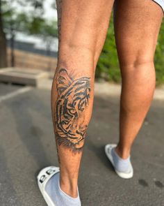 a man with a tiger tattoo on his leg