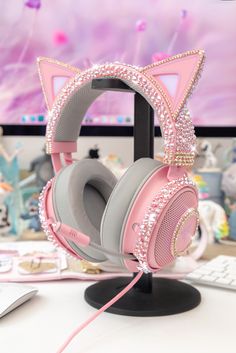 a pink kitty ear headphones on top of a computer desk