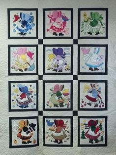 a quilted wall hanging with many different pictures on it