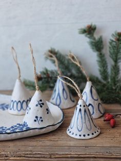 three white and blue ceramic cones on a wooden table