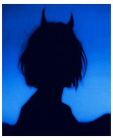 the silhouette of a person with horns on their head is shown in front of a blue background