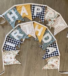 happy birthday bunting banner on wooden floor with fabric letters and gingham checkers