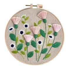 an embroidery project with pink and white flowers