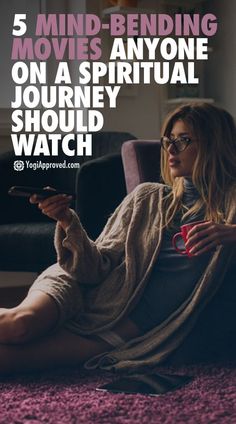 a woman is sitting on the floor with her feet up and holding a book in her hand