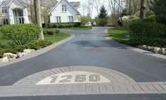 a street with a sign that reads 1230 on it and houses in the background