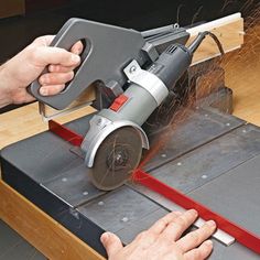 a person using a grinder on a piece of wood