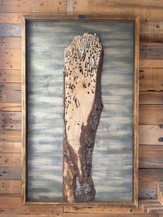 a piece of wood with birds on it in a frame