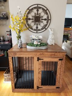 a wooden table topped with a metal clock and caged in dog kennels