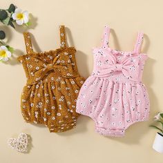 two baby girls'rompers with bows on the front and back, one in pink and one in brown