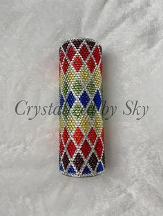 a multicolored beaded case on a white background