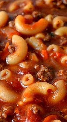 a close up view of some pasta and meat soup