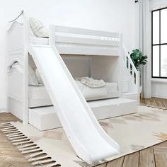 a white bunk bed with a slide in the middle