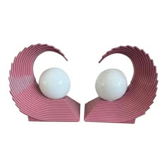 two pink and white objects sitting on top of each other