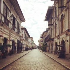 an old cobblestone street lined with buildings