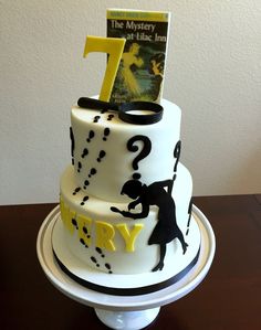 a birthday cake with the number one on it and an image of a person holding a book