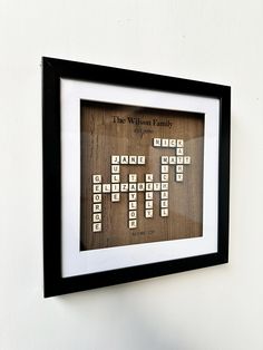 Create a meaningful family keepsake with our Personalized Scrabble Name Frame.  Handcrafted from natural wood and designed to fit your family names in a charming Scrabble board layout. Perfect for family gatherings, special occasions or as a heartfelt gift, this elegant piece of decor is available 29x29 cm and will effortlessly fit into any home. You can fully customize the names of your family members and give it a truly personal touch. This beautiful Scrabble art is not just a piece of decor, it is also a celebration of your family. Ideal for home decor lovers or as a unique family gift, it will add warmth and character to any space. Whether it is a birthday, anniversary or housewarming gift, this piece will leave a lasting impression. Can be customized to stand or hang on the wall. Perf Scrabble Family Names, Unique Family Gifts, Family Frame, Board Layout, Scrabble Board, Scrabble Art, Letter Tiles, Frame Christmas, Tree Custom