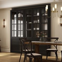 a dining room table and chairs in front of a black china cabinet with glass doors