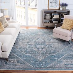 a living room filled with furniture and a blue rug