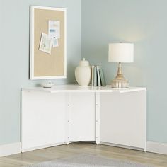 a living room with blue walls and a white cabinet next to a rug on the floor