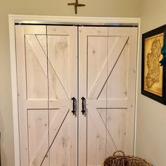 a large white barn style door in a living room next to a basket on the floor