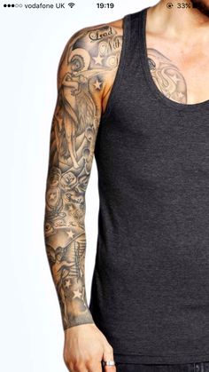 a man with tattoos on his arm and chest standing in front of a white background