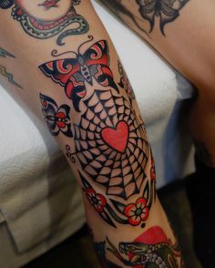 a woman's leg with tattoos on it and a tattoo design on the arm