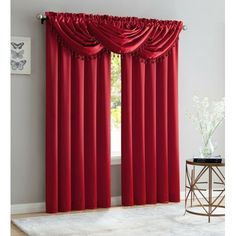 red curtains with ruffled edges in front of a white rug and window sill