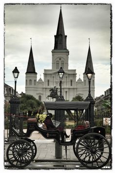 a horse drawn carriage sitting in front of a castle