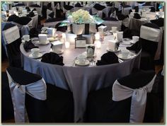 the tables are covered with black and white linens