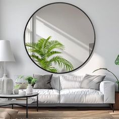 a living room filled with furniture and a large round mirror on the wall above it