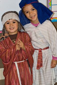 two young children dressed in native american clothing