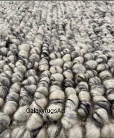 a large pile of gray and white yarn on top of each other, all over the floor