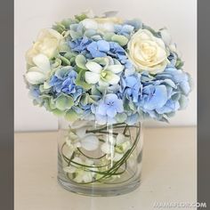 a vase filled with blue and white flowers