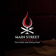 the main street social fine wines and fancy food logo is lit up with red lighting