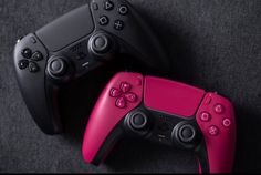 two video game controllers sitting next to each other