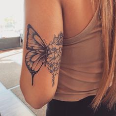 a woman with a butterfly tattoo on her arm