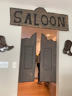 the door to saloon is decorated with cowboy boots