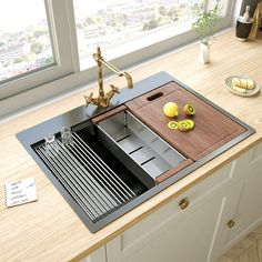 a kitchen sink sitting on top of a counter next to a wooden cutting board and knife