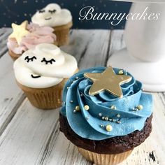 three cupcakes with blue frosting and stars on them