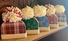 four christmas hats are lined up on a shelf