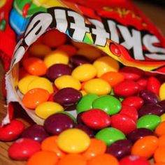 a bag filled with lots of candy sitting on top of a table