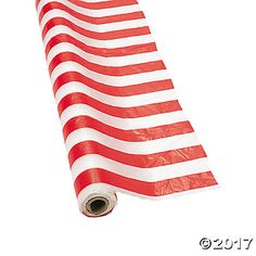 a red and white american flag laying on top of a roll of plastic wrapper