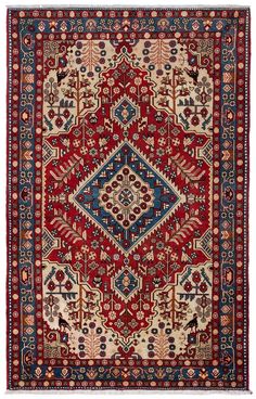 an antique persian rug with red, blue and white designs on the bottom half of it