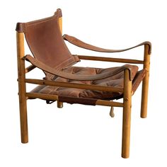 a brown leather chair sitting on top of a wooden frame