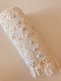 a white lace garter with buttons on it