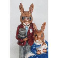 a figurine of two rabbits sitting next to each other