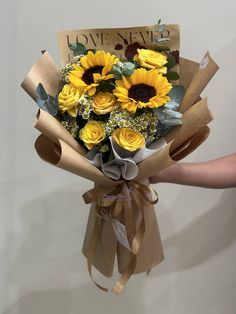 a bouquet of sunflowers wrapped in brown paper