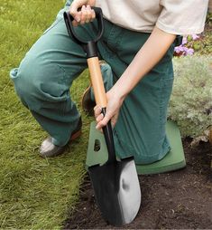 a person kneeling down with a shovel in their hand